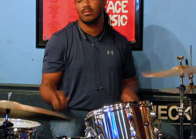 A man playing drums in an Atlanta room.