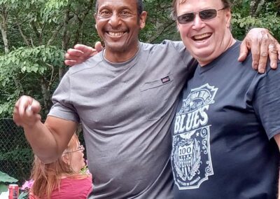 Two men standing together smiling at a blues music event in Atlanta.