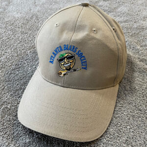 A beige baseball cap with the "atlanta blues society" logo embroidered on the front.