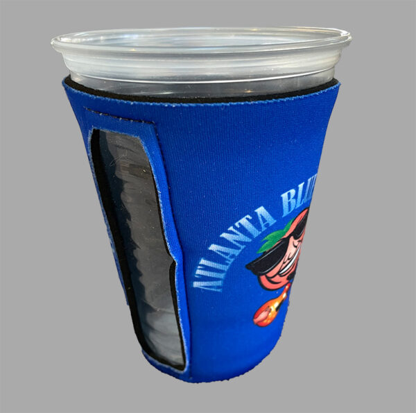 Blue beverage koozie with logo holding a clear plastic cup.