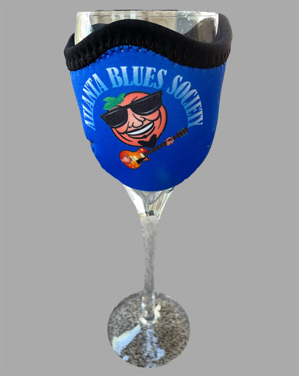 A blue wine glass with atlanta blues society logo and a black face mask around it.